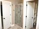 Modern bathroom showcasing a glass-enclosed shower and convenient access to the walk-in closet at 120 Glen Oaks Dr, Youngsville, NC 27596