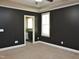 Spacious bedroom features a ceiling fan, neutral carpet, and a bathroom at 120 Glen Oaks Dr, Youngsville, NC 27596