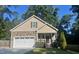 Charming home with a two-car garage, manicured lawn, and a mix of stone and shingle exterior at 120 Glen Oaks Dr, Youngsville, NC 27596