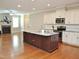 Open kitchen with stainless steel appliances, an island and sight lines to the living room at 120 Glen Oaks Dr, Youngsville, NC 27596