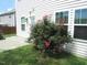 Exterior rear view of home showing the siding, manicured lawn, and rose bushes at 124 Richmond Run, Stem, NC 27581