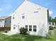 Exterior rear view of home showing the siding, manicured lawn, and access to the back door at 124 Richmond Run, Stem, NC 27581