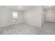 Bedroom with neutral walls, carpeted floor, and window overlooking the outdoor scenery at 125 Brook Pl, Smithfield, NC 27577