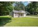 Well-maintained single-story home with neat lawn, side access, and neutral siding with complementary shutters at 125 Brook Pl, Smithfield, NC 27577