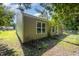 Side view of a single-Gathering home featuring neutral siding, windows, and mature trees providing shade at 125 Brook Pl, Smithfield, NC 27577