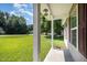 Front porch with supporting columns, window, and the house address, overlooking a lush green lawn at 125 Brook Pl, Smithfield, NC 27577
