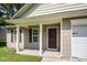 Welcoming front porch with classic columns, a stylish entry door, and a view of the front yard at 125 Brook Pl, Smithfield, NC 27577