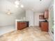 An eat-in kitchen features tile floors, wooden cabinets, and a door leading to the outside at 125 Brook Pl, Smithfield, NC 27577