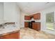 Kitchen with tan floors, wooden cabinets and black appliances at 125 Brook Pl, Smithfield, NC 27577