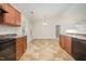 The kitchen overlooks the breakfast area and has black appliances and wood cabinets at 125 Brook Pl, Smithfield, NC 27577