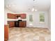 Kitchen with tan floors and wooden cabinets; a white door leads to the outside at 125 Brook Pl, Smithfield, NC 27577