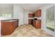 The kitchen area has wood cabinets, black appliances, and tan tiled floors at 125 Brook Pl, Smithfield, NC 27577