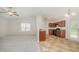 Open living room with plush carpeting leading to the kitchen with a tile floor and a partial wall divider at 125 Brook Pl, Smithfield, NC 27577