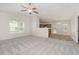 Spacious living room featuring neutral carpet and abundant natural light flowing into the adjacent dining area at 125 Brook Pl, Smithfield, NC 27577