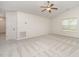 Bright living room features plush carpeting, neutral walls, a ceiling fan and entry door at 125 Brook Pl, Smithfield, NC 27577