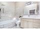 Beautiful bathroom with modern tiling, updated vanity, and combined shower and tub at 127 Creekwood, Pittsboro, NC 27312