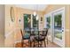 Cozy breakfast nook with a glass table, view of outside greenery and French doors leading to the porch at 127 Creekwood, Pittsboro, NC 27312