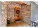 Inviting stone entryway with beautiful wood door and festive wreath at 127 Creekwood, Pittsboro, NC 27312