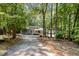 Secluded gray home with a lush, wooded lot and long driveway at 127 Creekwood, Pittsboro, NC 27312