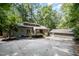 Charming gray home featuring a separate garage, clerestory windows, and wooded lot at 127 Creekwood, Pittsboro, NC 27312