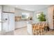 Bright kitchen featuring white cabinets, granite countertops, and a breakfast bar at 127 Creekwood, Pittsboro, NC 27312