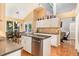 Bright kitchen featuring granite countertops, stainless steel appliances, and a herringbone floor at 127 Creekwood, Pittsboro, NC 27312