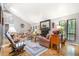 Open living room with a fireplace, skylight, and dining area at 127 Creekwood, Pittsboro, NC 27312