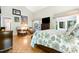 Bright main bedroom featuring parquet floors, large windows, and a sitting area at 127 Creekwood, Pittsboro, NC 27312