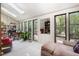 Sunroom featuring natural light and multiple seating areas, perfect for relaxation at 127 Creekwood, Pittsboro, NC 27312