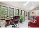 Sunroom featuring multiple windows with a beautiful view of the surrounding greenery at 127 Creekwood, Pittsboro, NC 27312