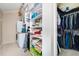 Walk-in closet with organized shelving and ample storage space, next to the laundry area at 127 Creekwood, Pittsboro, NC 27312