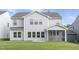 Exterior backyard view of a two-story home with gray siding and a screened-in porch at 130 Summer Mist Ln # 160, Clayton, NC 27527