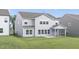 Lush backyard showcases a home's well-maintained lawn, a screened-in patio, and gray siding at 130 Summer Mist Ln # 160, Clayton, NC 27527