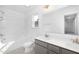 Bright bathroom with double sink vanity, shower-tub combo, and a large mirror at 130 Summer Mist Ln # 160, Clayton, NC 27527