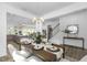 Bright dining room adjacent to the kitchen and living room, featuring white walls and modern decor at 130 Summer Mist Ln # 160, Clayton, NC 27527
