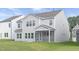 View of the rear exterior of a home with a screened-in porch and a well-manicured lawn at 130 Summer Mist Ln # 160, Clayton, NC 27527