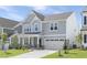 Charming two-story home with gray siding, manicured lawn, and attached two car garage at 130 Summer Mist Ln # 160, Clayton, NC 27527