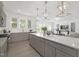 Open kitchen featuring a large island with seating, quartz countertops, and stainless steel appliances at 130 Summer Mist Ln # 160, Clayton, NC 27527