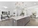 Open kitchen featuring a large island with seating, quartz countertops, and stainless steel appliances at 130 Summer Mist Ln # 160, Clayton, NC 27527