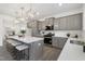 Open kitchen featuring a large island with seating, quartz countertops, and stainless steel appliances at 130 Summer Mist Ln # 160, Clayton, NC 27527