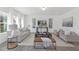 Bright living room with contemporary decor, large windows, and neutral color palette at 130 Summer Mist Ln # 160, Clayton, NC 27527
