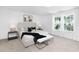 Bright main bedroom featuring large windows, soft carpet, and modern decor at 130 Summer Mist Ln # 160, Clayton, NC 27527