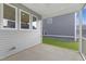 Covered patio with screened opening and windows offer a cozy outdoor space at 130 Summer Mist Ln # 160, Clayton, NC 27527