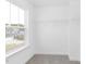 Bright walk-in closet featuring a window and adjustable white shelving for ample storage at 130 Summer Mist Ln # 160, Clayton, NC 27527