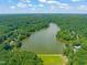 A serene lake surrounded by lush greenery, creating a peaceful and scenic view at 1317 Elmset Ln, Durham, NC 27713