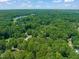 Aerial view of a beautiful lake, a wooded area, and homes in a pleasant neighborhood at 1317 Elmset Ln, Durham, NC 27713