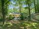 Spacious backyard featuring patio, fire pit, chairs, and lush landscaping at 1317 Elmset Ln, Durham, NC 27713