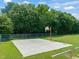 Full basketball court with a hoop, surrounded by a chain fence and a grassy landscape at 1317 Elmset Ln, Durham, NC 27713