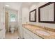 Bathroom featuring a double vanity with granite countertop and neutral tiled floor at 1317 Elmset Ln, Durham, NC 27713