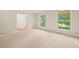Spacious bedroom with neutral carpet, natural light, and a view of the green outdoor space at 1317 Elmset Ln, Durham, NC 27713